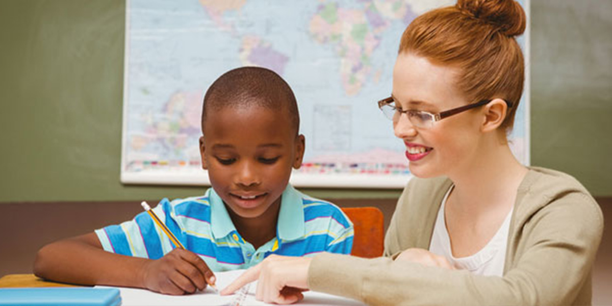 A woman is helping a boy with his homework.